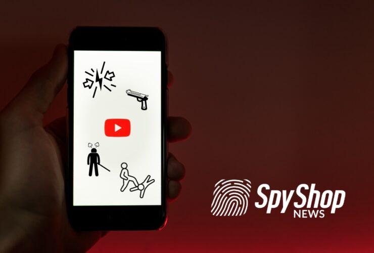 Telefon w dłoni. Uruchomiona aplikacja YouTube. Symbole przemocy na ekranie.