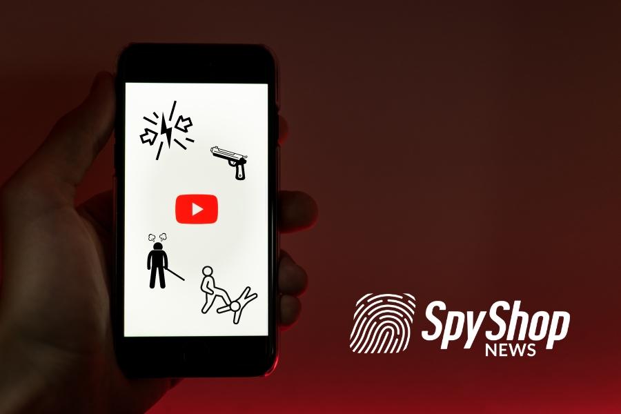 Telefon w dłoni. Uruchomiona aplikacja YouTube. Symbole przemocy na ekranie.